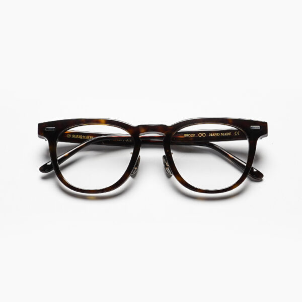 Handcrafted in warm, earthy tones, these Japanese-inspired sunglasses worn by a model